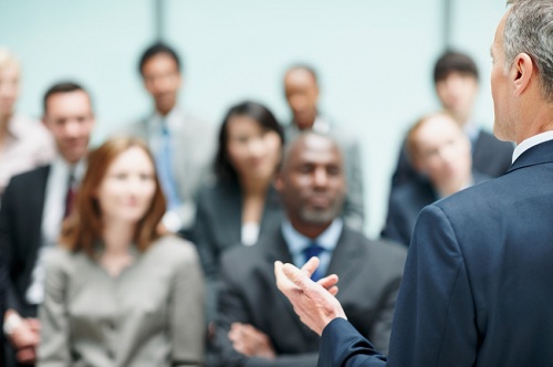 A man giving a seminar in a conference room.